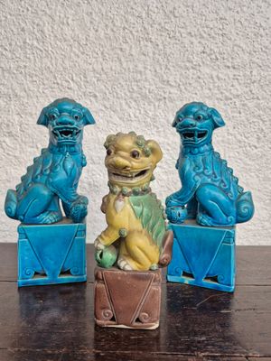 three figurines of foo foo foo sitting on a table