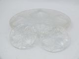 a white plate that has four pieces of plastic on top of it