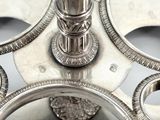 a close up of a silver candle holder with a lion on it