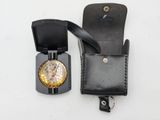 a black leather case with a watch inside of it