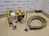 an image of a machine with a hose next to it