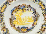 a yellow and blue plate with a picture of a man riding a horse