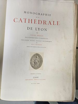 an old book sitting on top of a table next to a wall