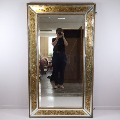 a woman taking a picture of herself in a mirror