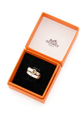 a box with a ring inside of it on a white surface