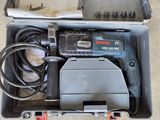 a box with a drill and other tools inside of it