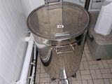an image of a stainless steel trash can in a bathroom