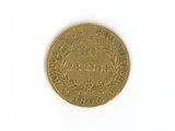 a close up of a gold coin on a white surface