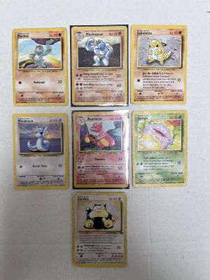 several pokemon cards are on a white surface with a white background