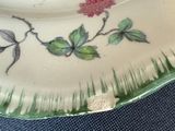 a plate with a flower design on it sitting on a table
