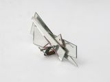 a small metal object that is sitting on a white surface