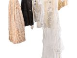 three dresses hanging on a clothes rack on a white background