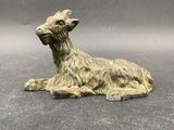 a small figurine of a goat on a table