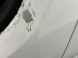 a close up of a car ' s tire with a hole in it
