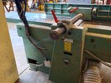 a machine that is working on a piece of wood