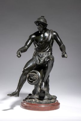 a bronze statue of a man holding a basketball ball on a marble base