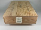 two wooden boxes with labels on them sitting on a white surface