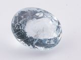 a close up of a blue diamond on a white surface