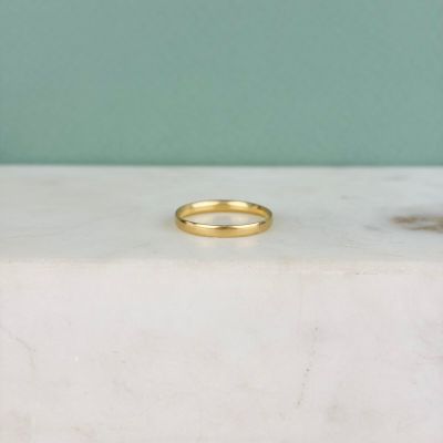 a picture of a gold ring on a marble slab