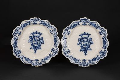 a pair of blue and white plates with floral designs on them