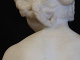 marble statue of a woman with her back turned to the side