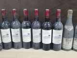 several bottles of wine are lined up on a table