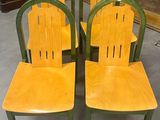 quatre chaises en bois placées devant un tableau
