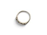 a close up of a gold ring on a white surface