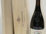 a bottle of wine next to a wooden box