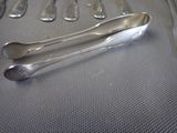 a lot of silver spoons and forks on a table