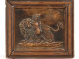a bronze plaque depicting a lion and a woman on a rock