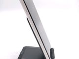 a cell phone on a stand on a white surface