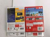 two nintendo wii games sitting on top of each other on a table