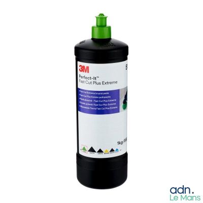 a bottle of black ink sitting on top of a white surface