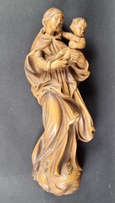 an image of a statue of a woman holding a child