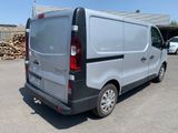 a silver van that is parked in a parking lot