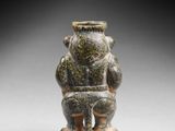 a small stone figurine of a man with a hat on his head