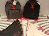 three bags that are sitting on a bed