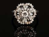 a close up of a diamond ring on a black surface