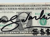 an image of a one dollar bill with a signature on it
