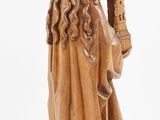 a wooden statue of a man with a beard holding a sword