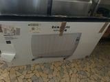 a box with a microwave inside of it sitting on the floor