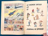 a person holding a book open to a page of comics