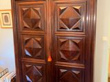 an image of a large wooden armoire in a living room