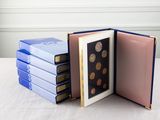 several books stacked on top of each other on a table