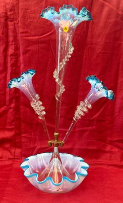 a glass vase with flowers in it on a red background