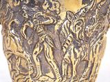 a gold vase with a picture of a man and a woman