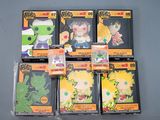 six different dragon ball figures in plastic packaging on a gray surface
