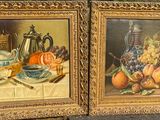 two paintings of fruit and a teapot sit on a ledge