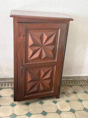 a small wooden cabinet with a door on the floor